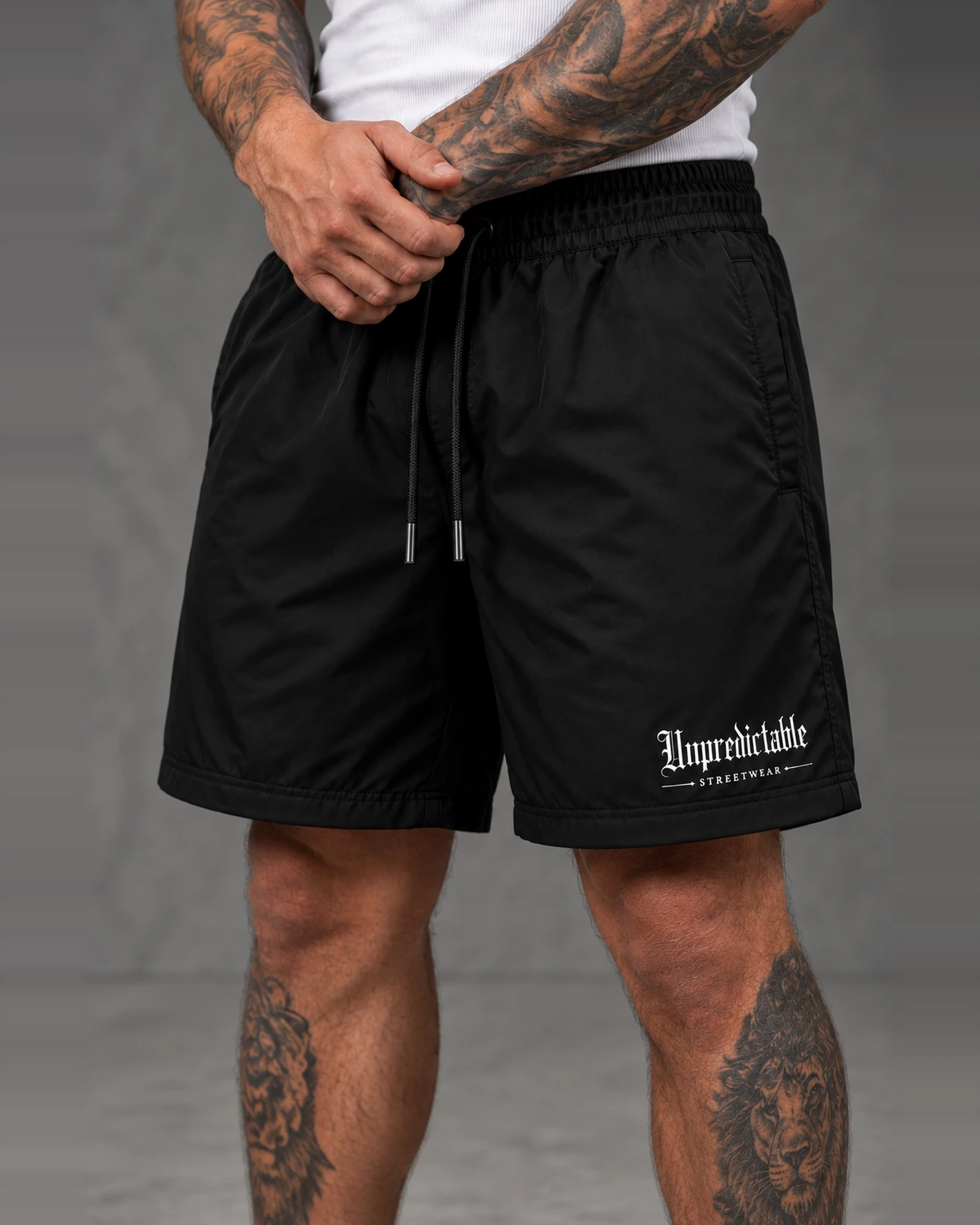 Unpredictable Board Shorts in black, worn front view